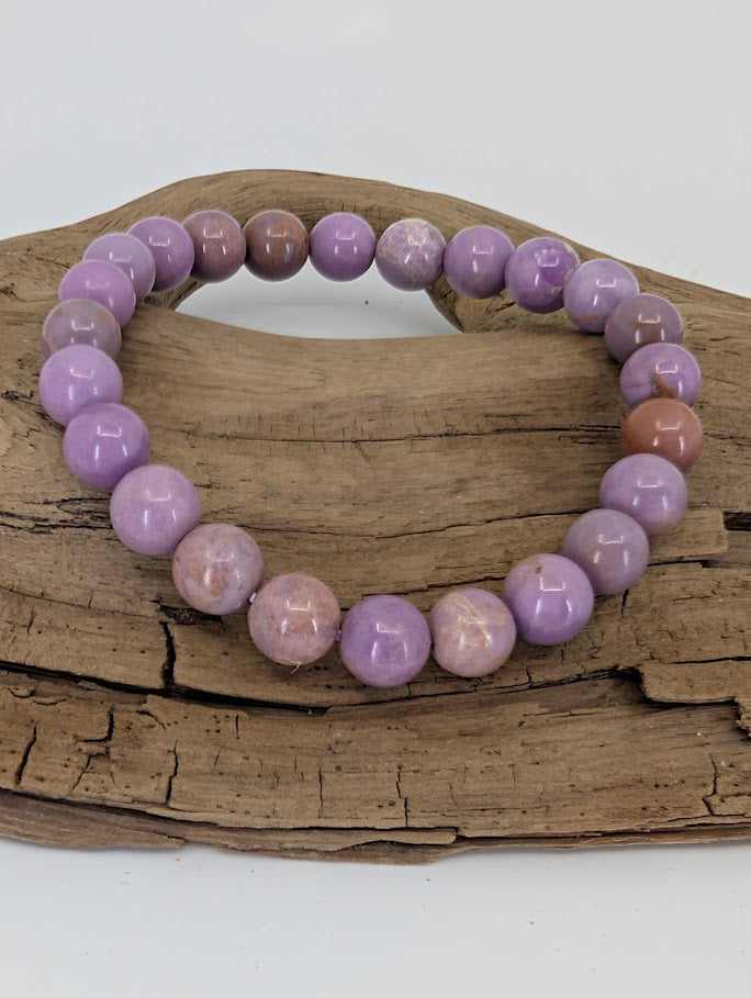Top-down image showing uniform 8mm Phosphosiderite beads with mauve and beige variation