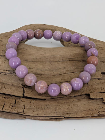Top-down image showing uniform 8mm Phosphosiderite beads with mauve and beige variation
