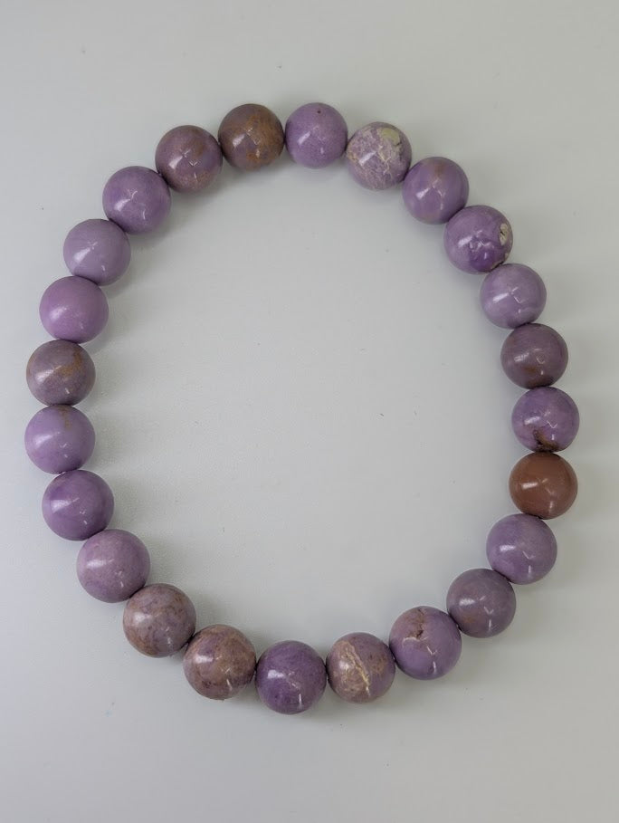 Flat lay of Phosphosiderite bracelet highlighting smooth bead finish and soft tones