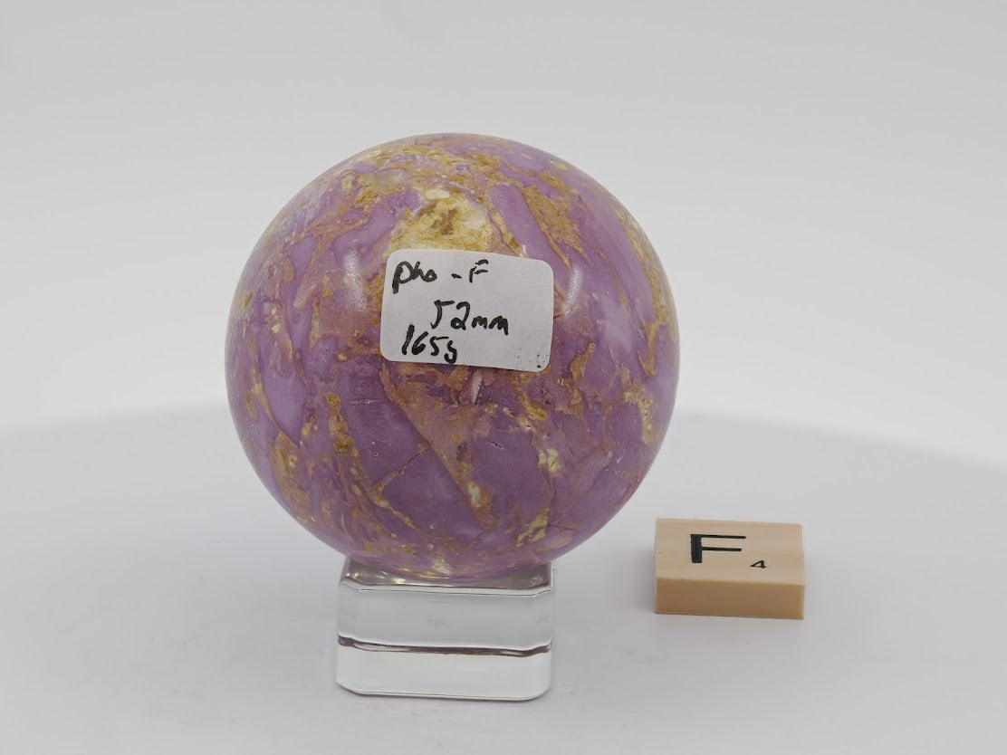 Side profile of a 58mm Phosphosiderite sphere from Chile, showing vibrant magenta swirls and natural surface textures.
