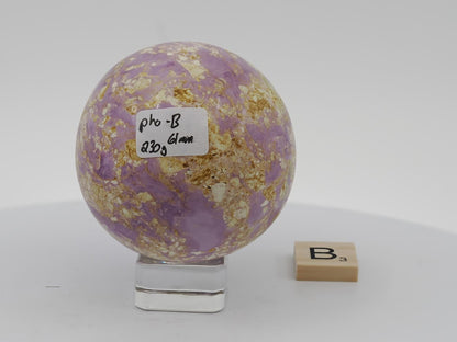 Polished 61mm lavender Phosphosiderite sphere with speckled white and tan matrix inclusions.