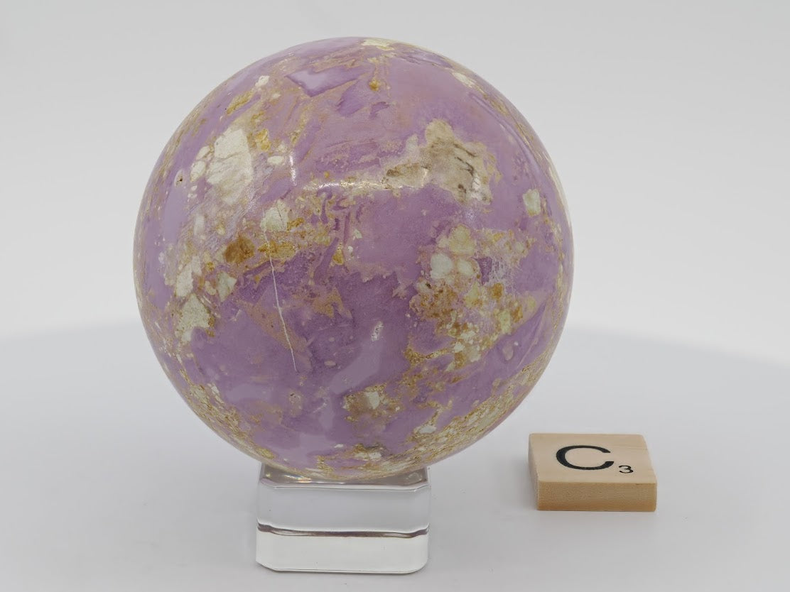 Polished 63mm lilac Phosphosiderite sphere with intricate natural veining and landscape patterns.