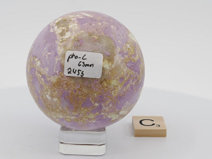 63mm orchid-purple Phosphosiderite sphere with bold yellow-tan cacoxenite veins.
