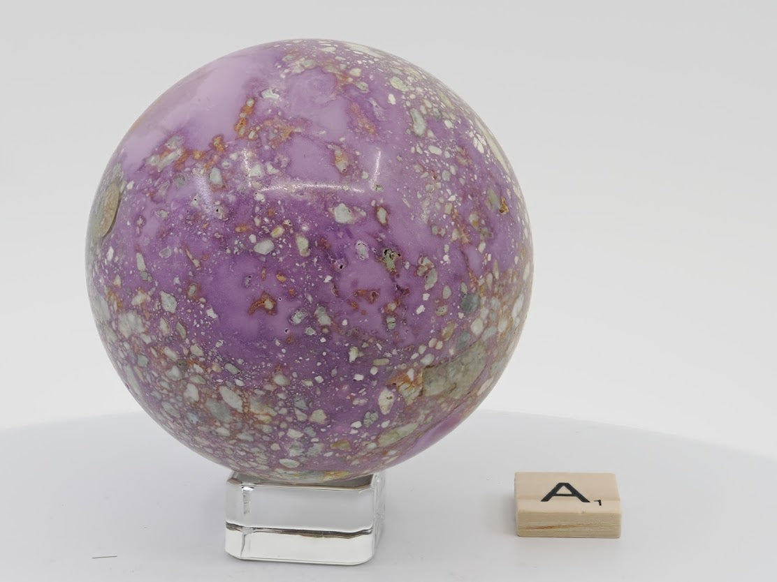Detailed view of a 74mm Phosphosiderite sphere showing rare natural mosaic patterns and iron phosphate structure.