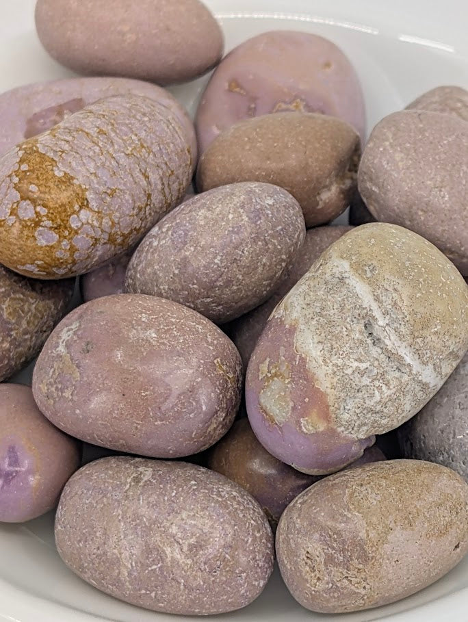 Close-up of Phosphosiderite tumbled stones showing lilac texture