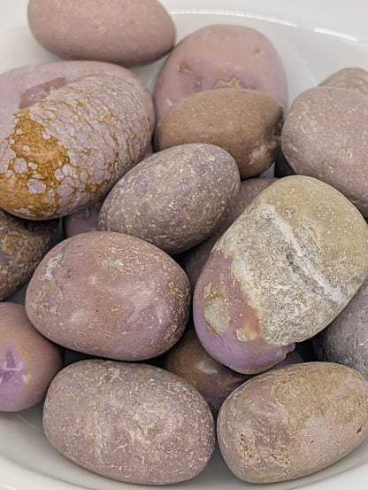 Close-up of Phosphosiderite tumbled stones showing lilac texture