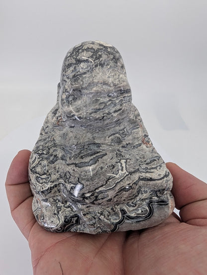 Handheld Picasso Jasper Laughing Buddha carving highlighting size and polished detail