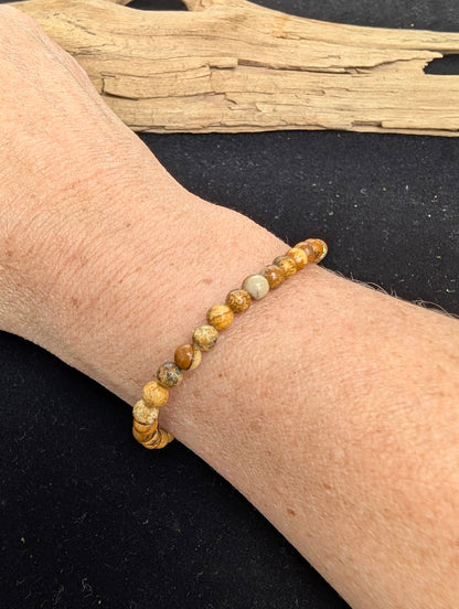 4mm smooth Picture Jasper beaded stretch bracelet worn on a wrist for delicate size scale.