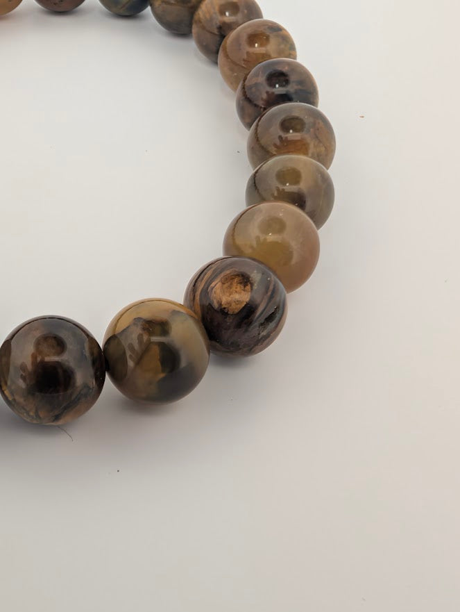 Macro of Pietersite bead with chatoyant golden flash