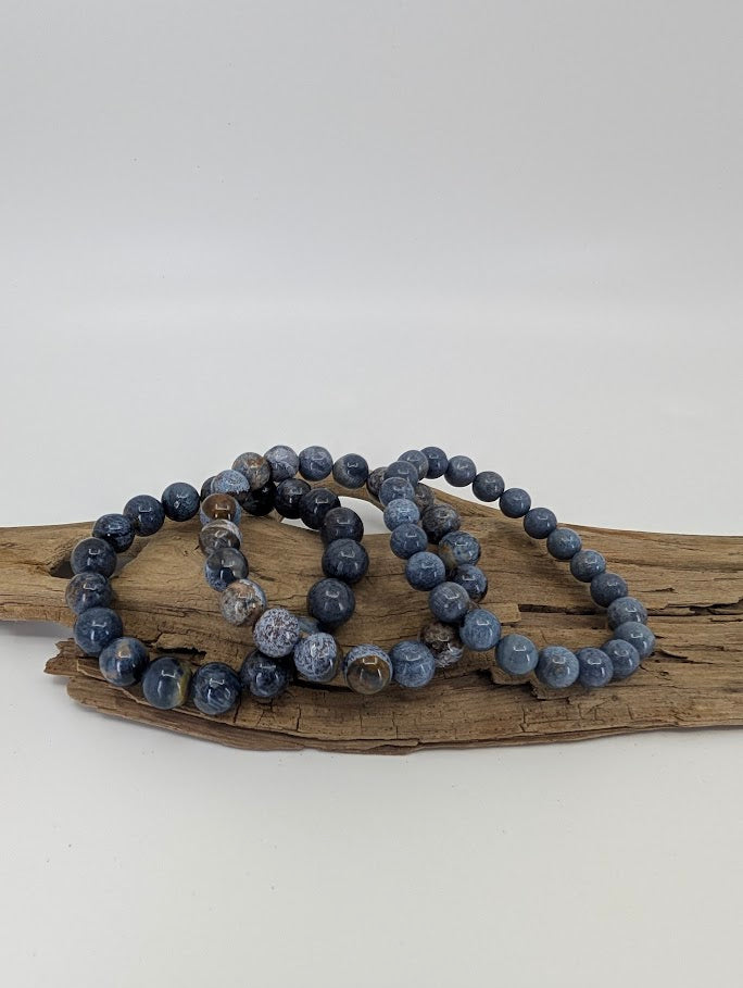 Blue Pietersite Stormlight bracelets in natural light showing deep navy and silver chatoyancy