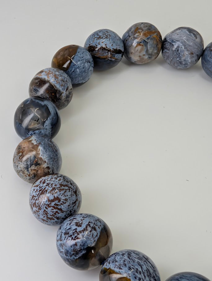 Close-up of 10MM Blue Pietersite bracelet showing mirror polish and swirling indigo fibers