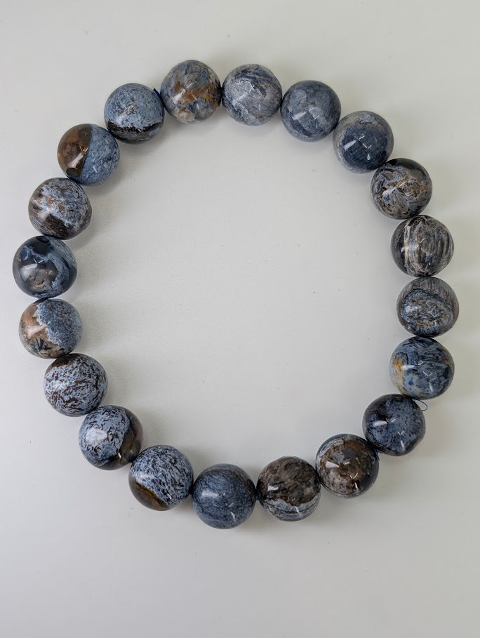 Top-down image of 10 mm Blue Pietersite bracelets with stormy color pattern