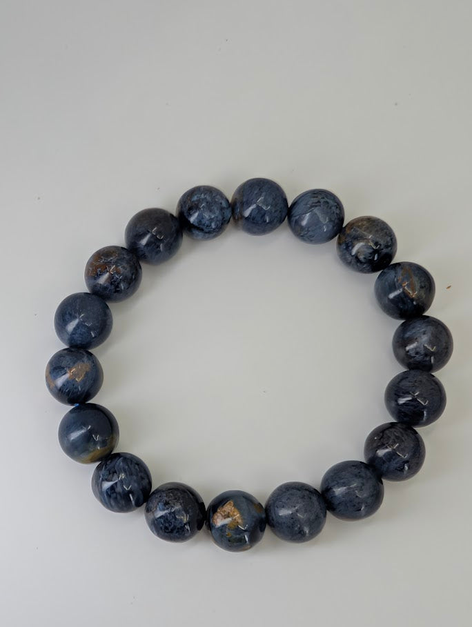Top-down image of 11 mm Blue Pietersite bracelets with stormy color pattern