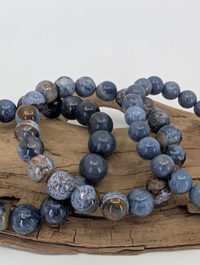 Macro photo of Blue Pietersite bracelet revealing preserved crocidolite fibers and metallic sheen