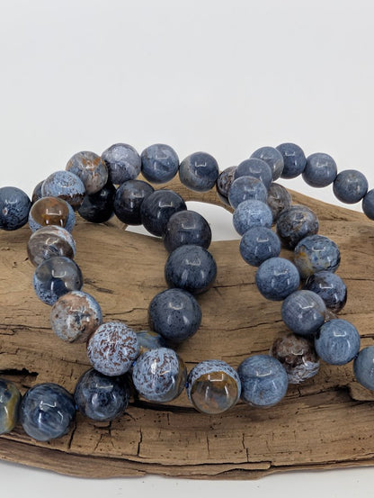 Macro photo of Blue Pietersite bracelet revealing preserved crocidolite fibers and metallic sheen