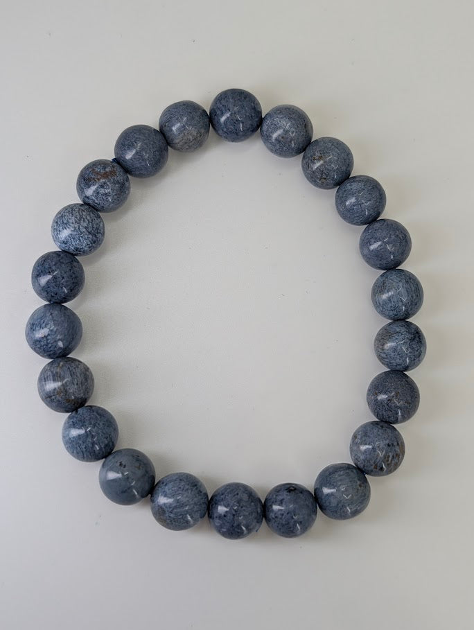 Flat lay of Blue Pietersite 8MM bracelets displaying storm-toned palette and high gloss