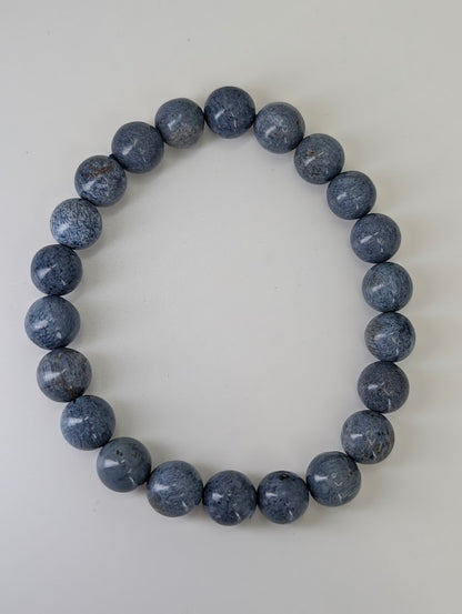 Flat lay of Blue Pietersite 8MM bracelets displaying storm-toned palette and high gloss