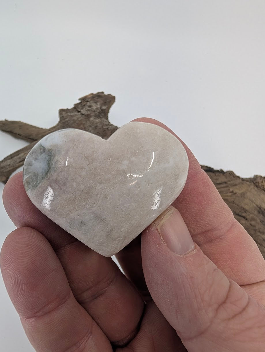 Hand holding a 50g Pink Amethyst heart showing polished texture.