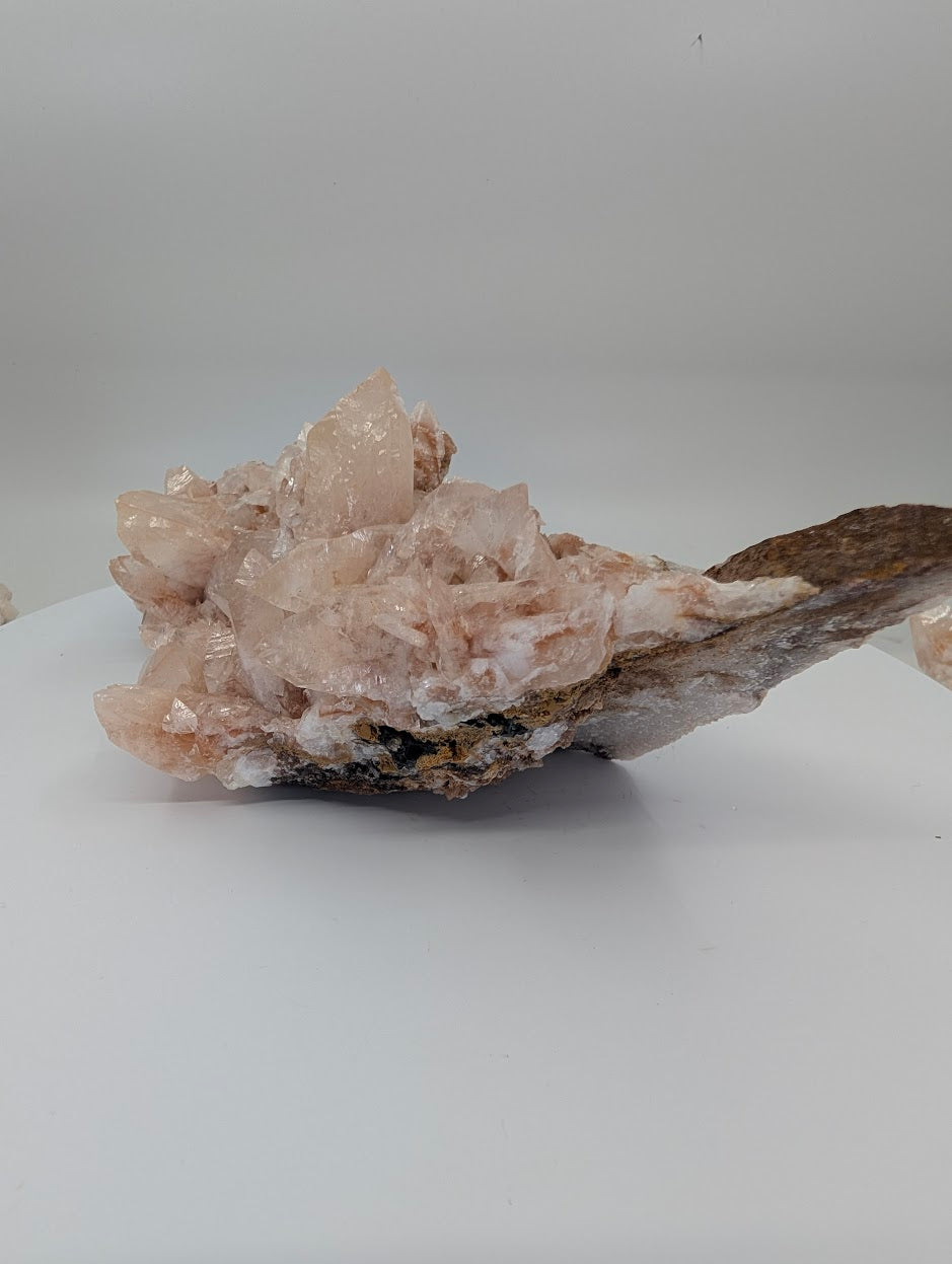 All-natural swallowtail pink calcite cluster from Hunan China - angled view