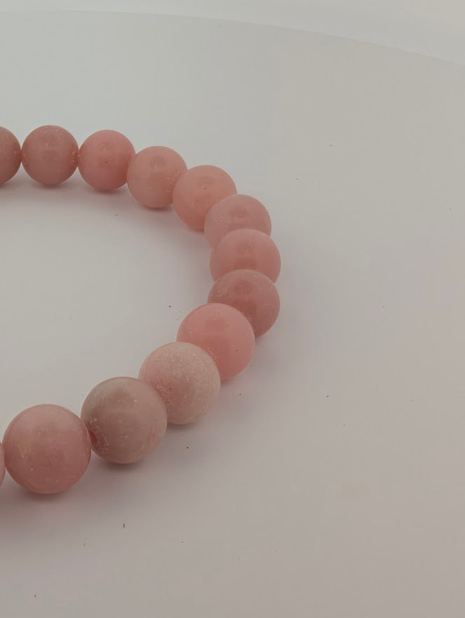 Detail of Pink Opal beads showing cloud-like patterns