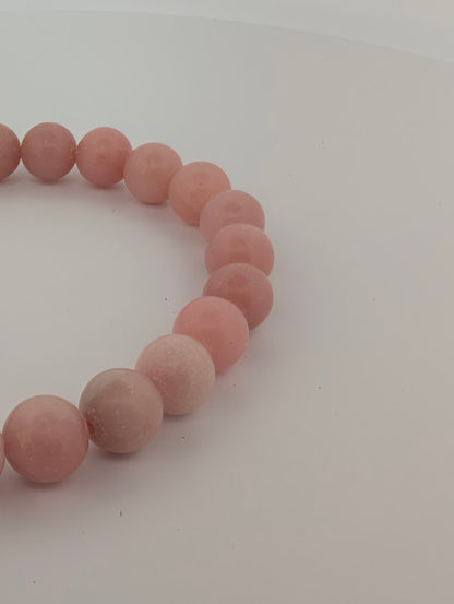 Detail of Pink Opal beads showing cloud-like patterns