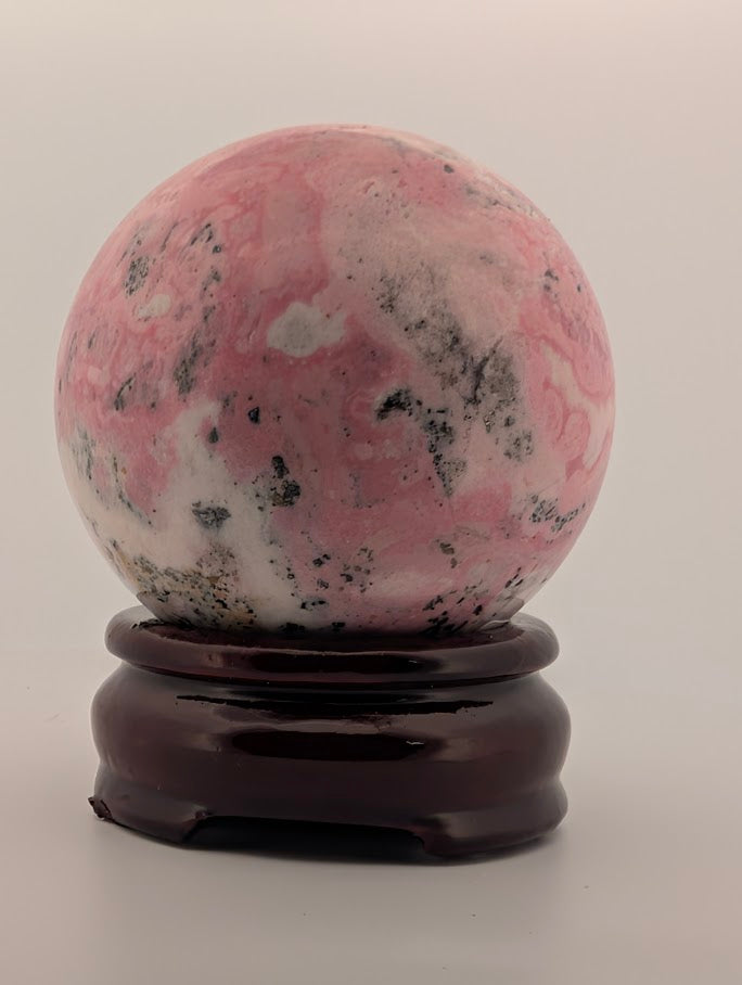 Rear view of Peruvian rhodonite sphere showing natural veining