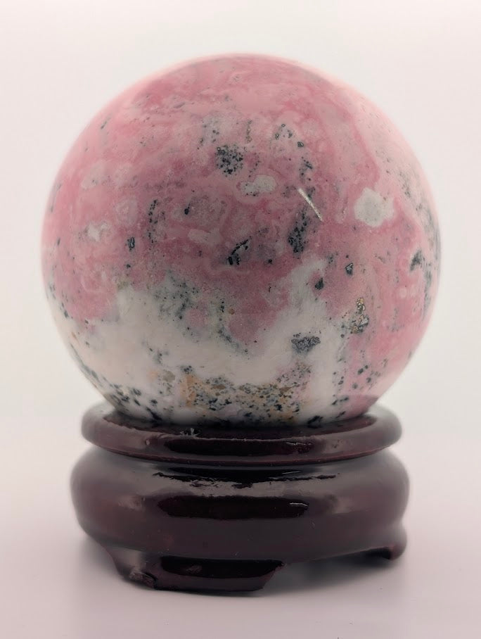 Close-up of rhodonite sphere highlighting texture and matrix pattern