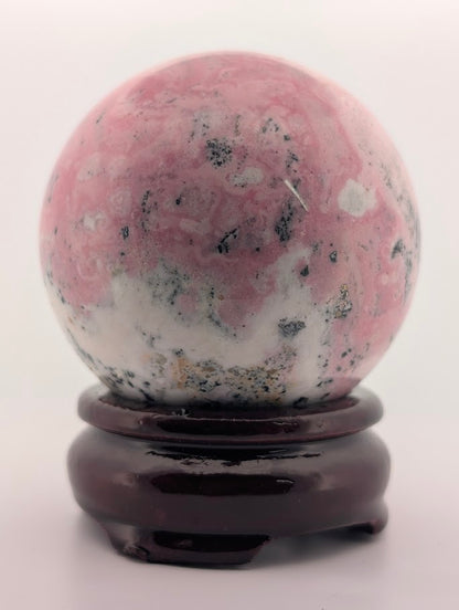 Close-up of rhodonite sphere highlighting texture and matrix pattern