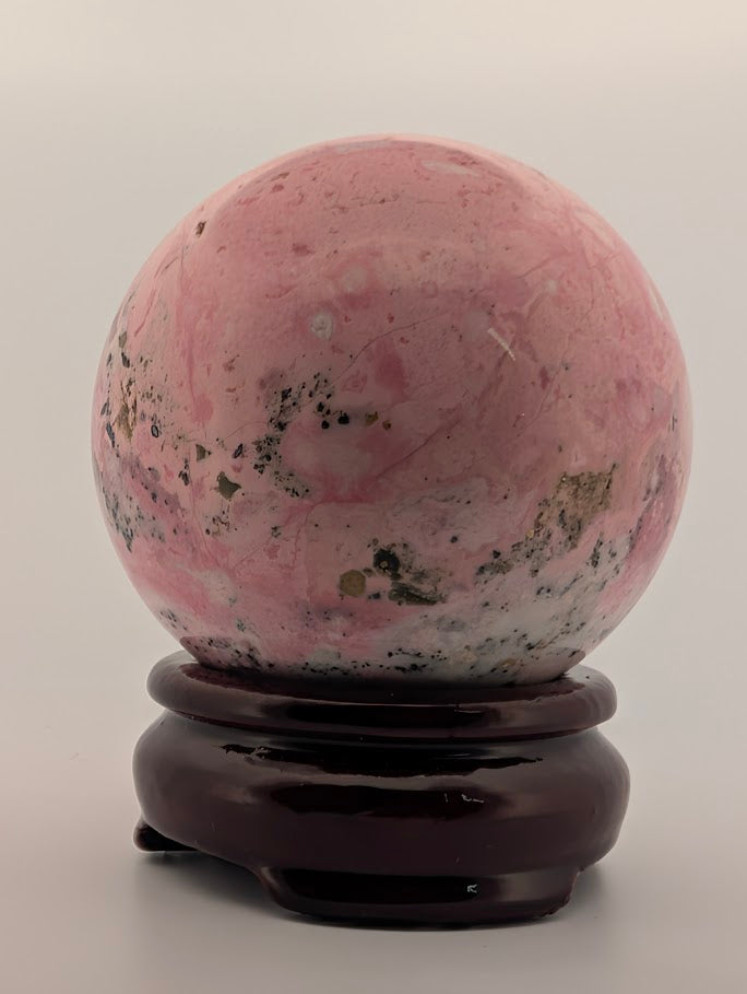 Front view showing pink and white veining with black inclusions