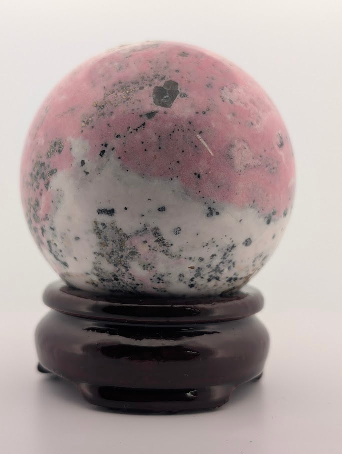 Front view of Pink Peruvian Rhodonite sphere showing pink and white gradient