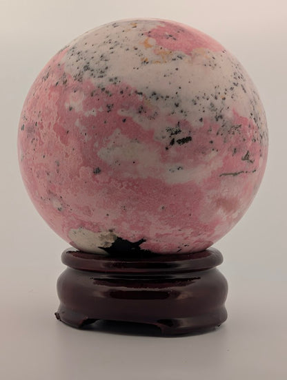 Front view showing pink and white banding with black inclusions