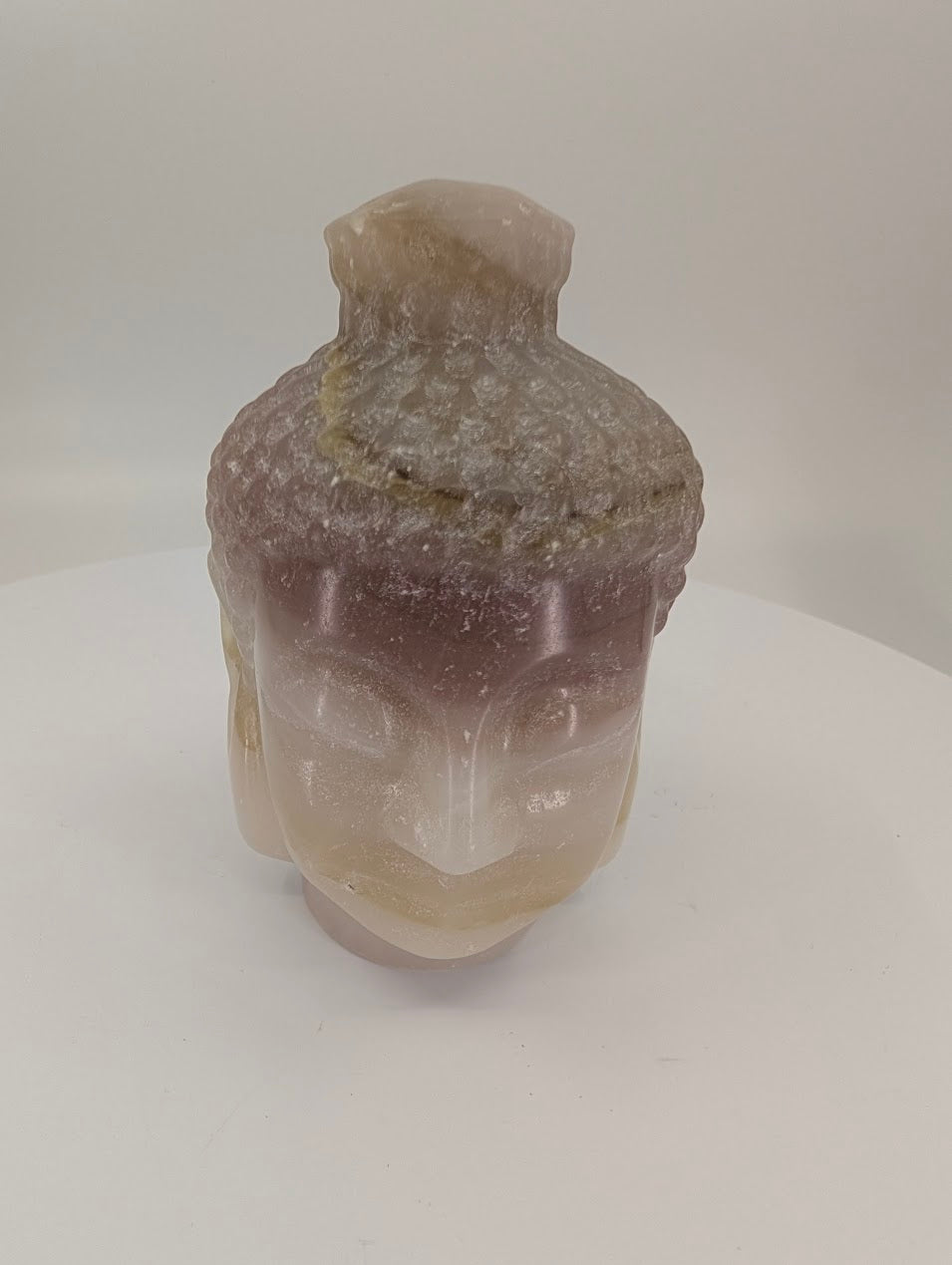 Pink Pistachio Calcite Buddha head carving, 9 cm tall, front view