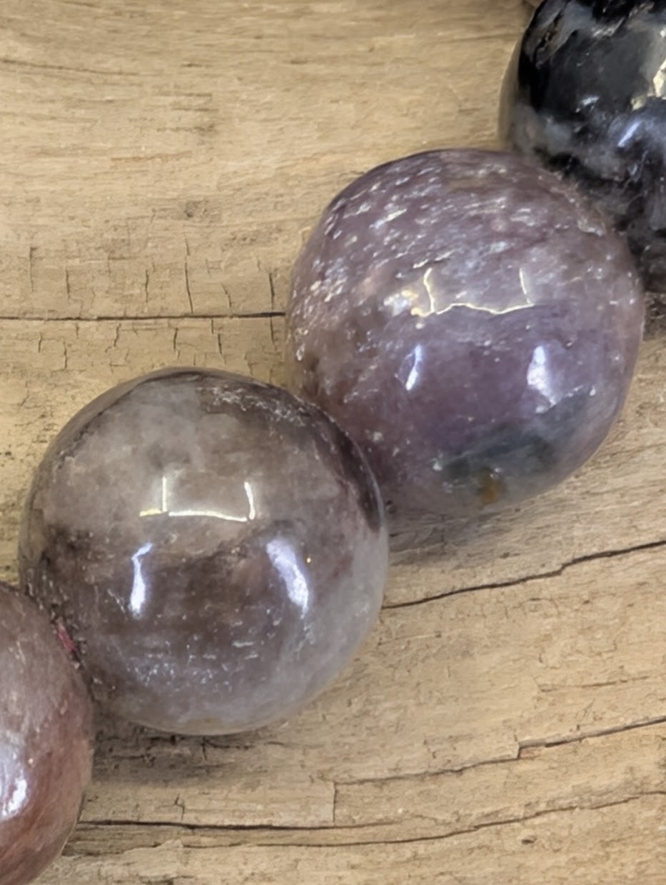 Detail view of 12mm Pink Tourmaline spheres highlighting the natural variations in rubellite saturation.
