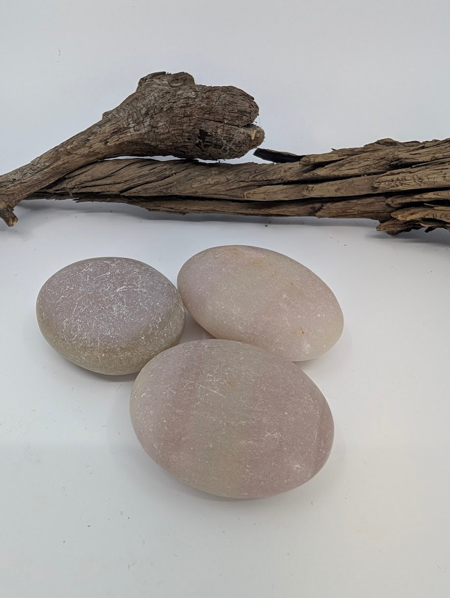 Pistachio Calcite palm stone with soft green and blush pink calcite tones