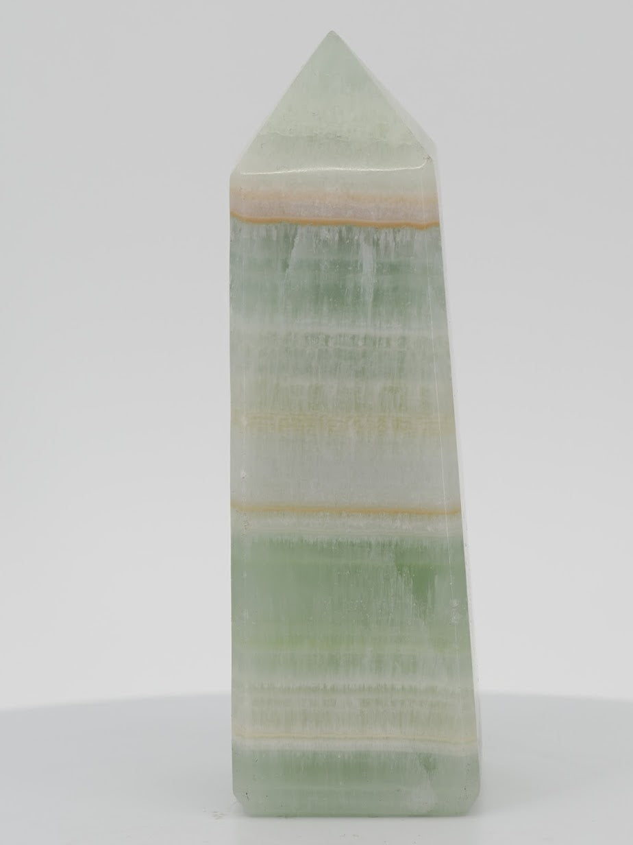 Polished Pistachio Banded Calcite tower featuring vibrant mint green, white aragonite, and thin orange mineral bands.