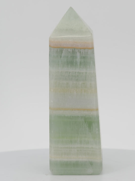 Polished Pistachio Banded Calcite tower featuring vibrant mint green, white aragonite, and thin orange mineral bands.