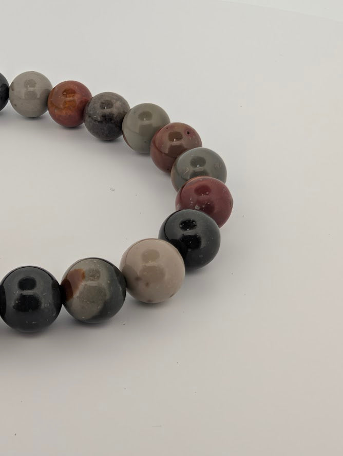 Detail of 8MM Polychrome Jasper bracelet highlighting glossy finish