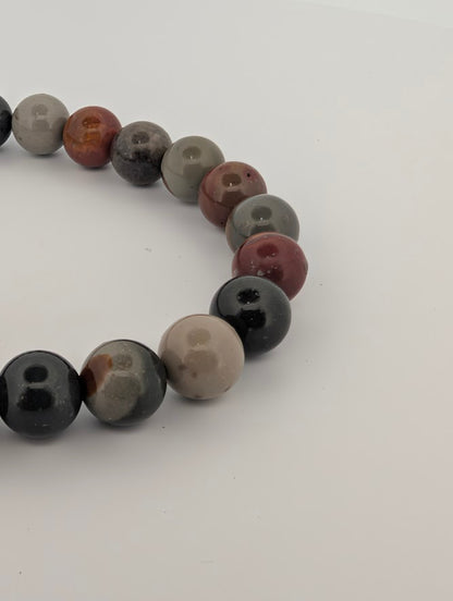 Detail of 8MM Polychrome Jasper bracelet highlighting glossy finish