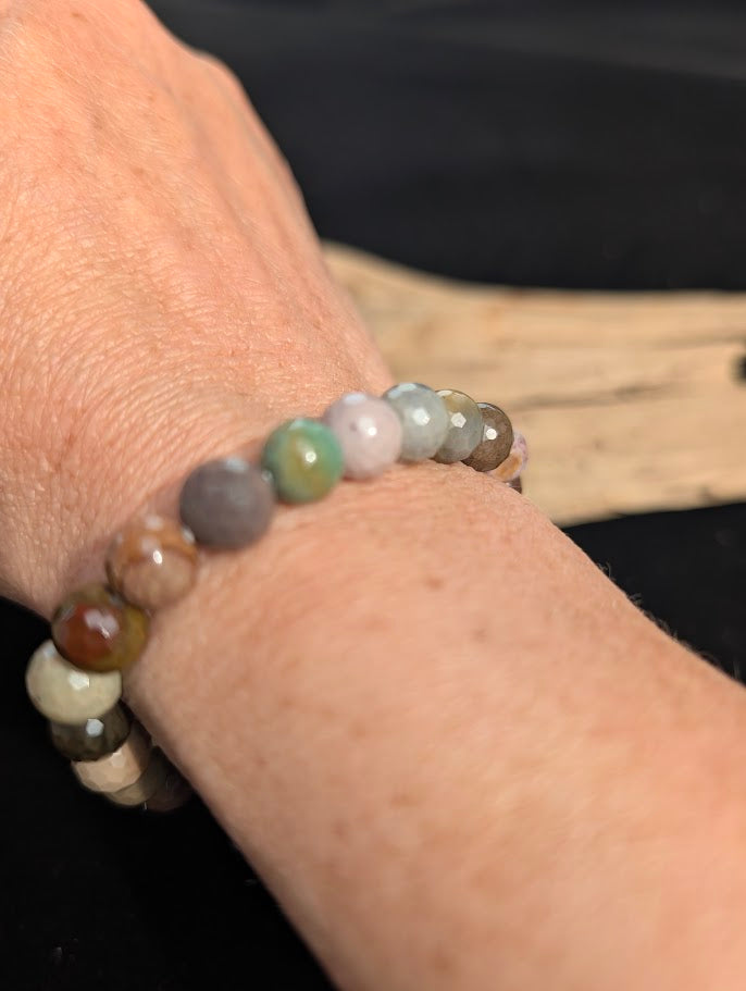8mm faceted Polychrome Jasper beaded stretch bracelet worn on a wrist for size scale.