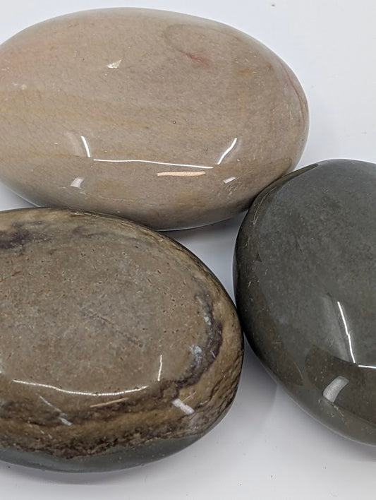 Close-up of Polychrome Jasper Palm Stone highlighting layered tones