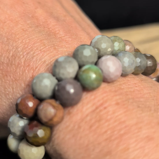Video showcasing the highly reflective faceted texture and varied earthy desert tones of an 8mm Polychrome Jasper beaded stretch bracelet worn on a wrist.