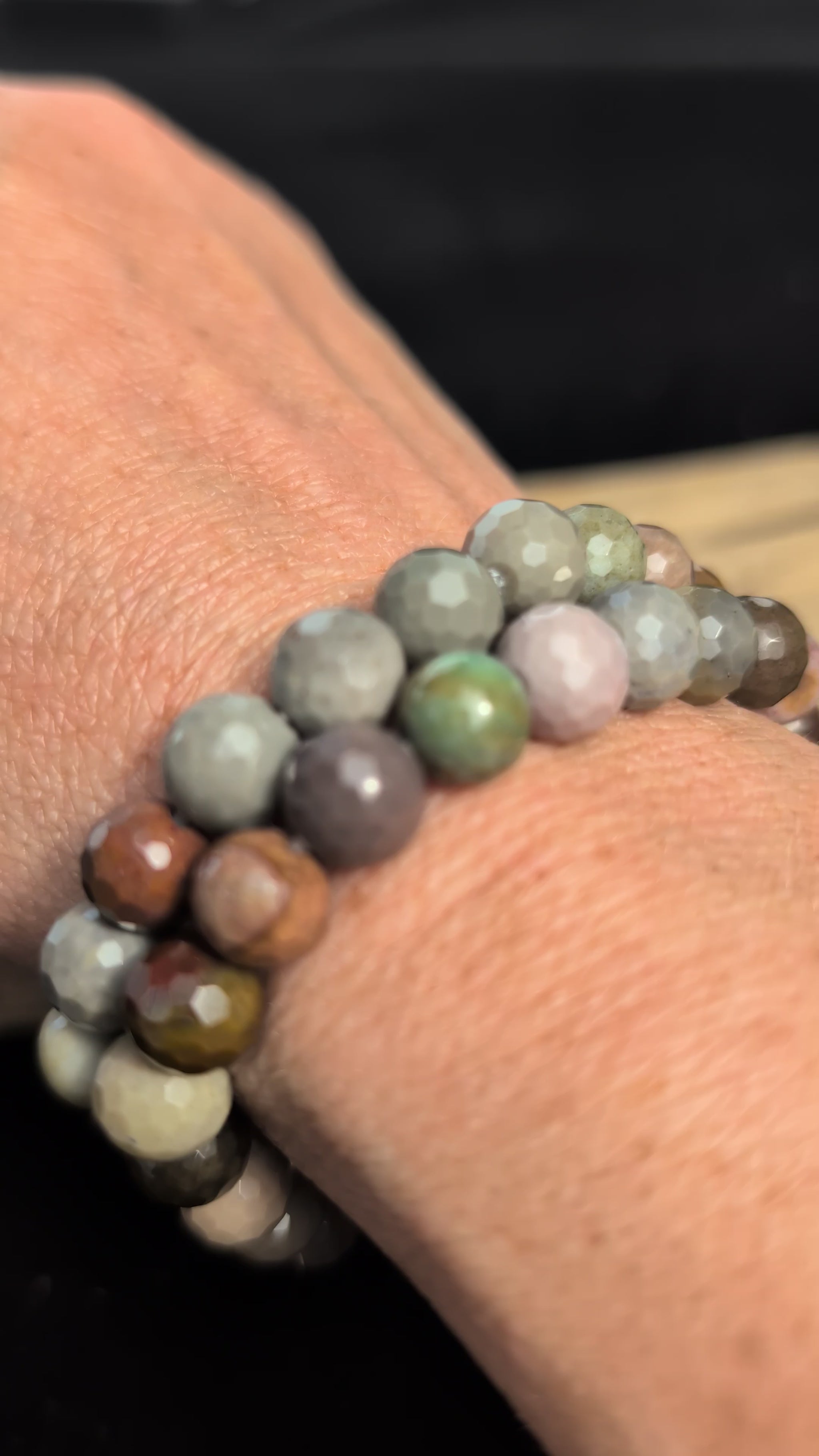 Video showcasing the highly reflective faceted texture and varied earthy desert tones of an 8mm Polychrome Jasper beaded stretch bracelet worn on a wrist.
