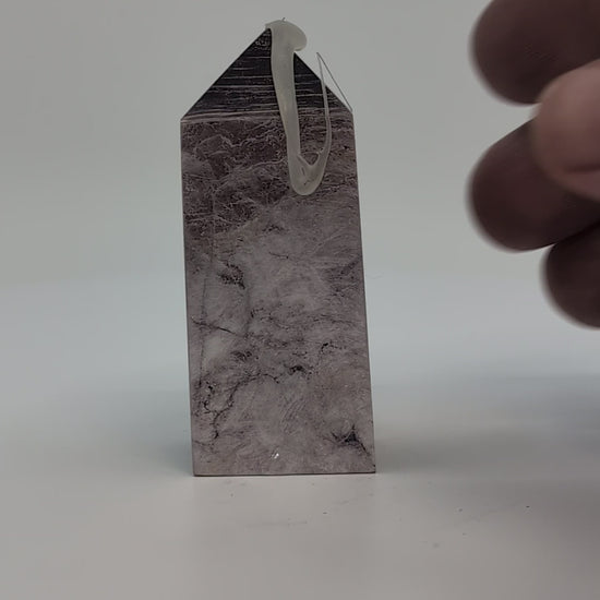 360° video showing the front of polished Lepidolite tower with lavender tones and silvery mica sheen