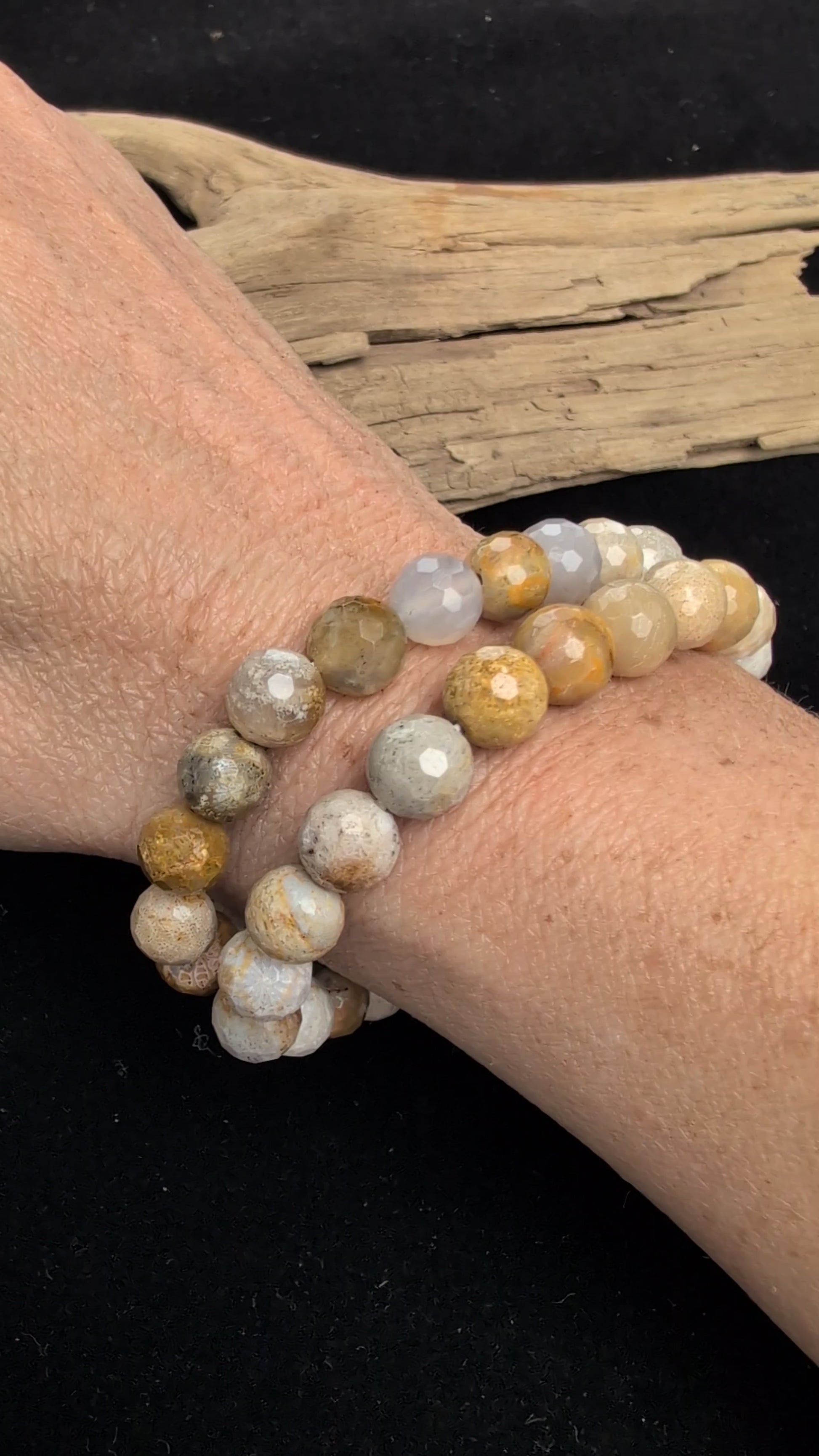 Video showcasing the highly reflective faceted texture and natural earthy, floral fossil patterns of an 8mm Coral Jade beaded stretch bracelet worn on a wrist.