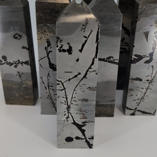 360° view of polished Picture Jasper towers from China, showing natural banding and warm desert hues.