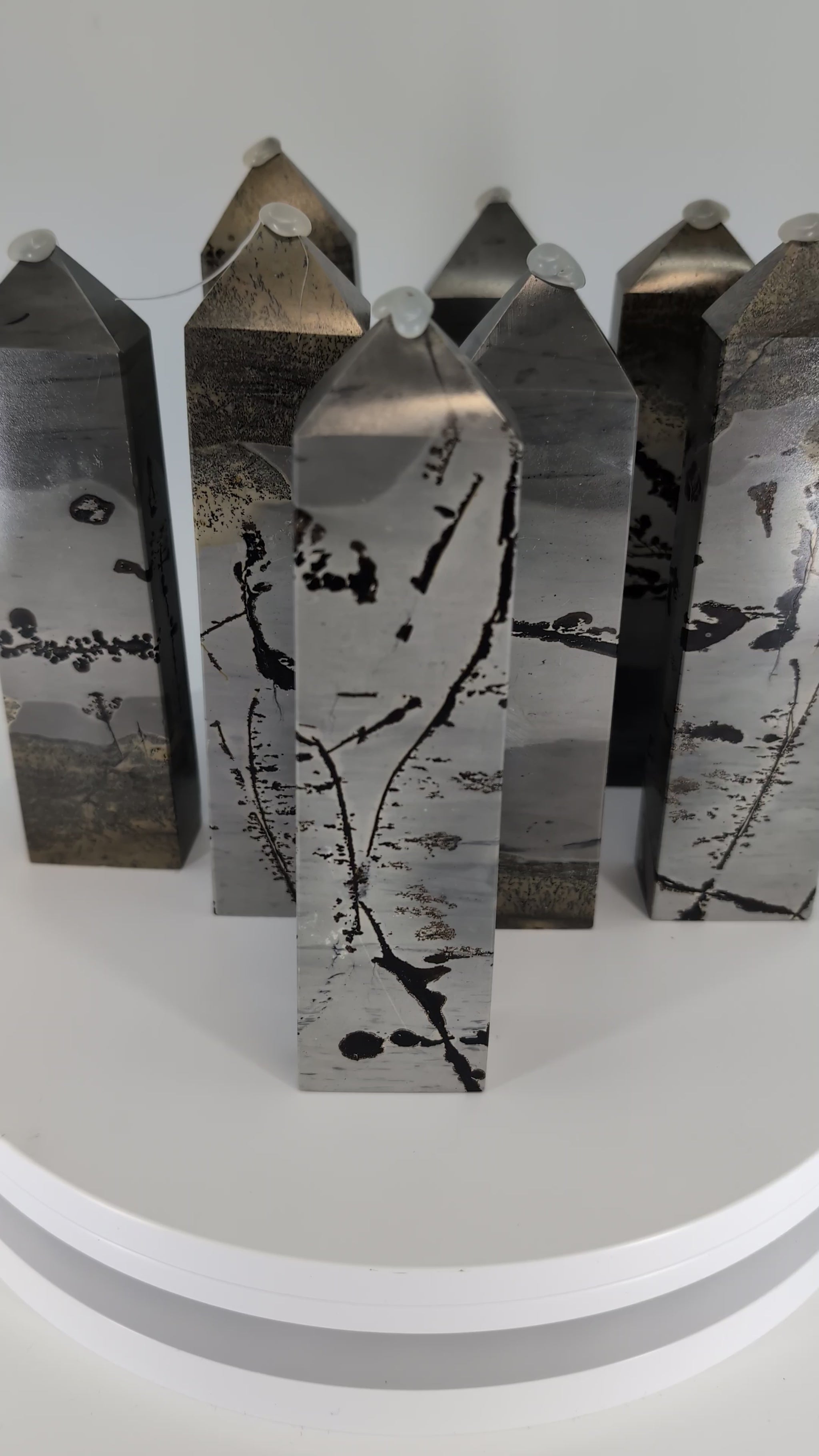 360° view of polished Picture Jasper towers from China, showing natural banding and warm desert hues.