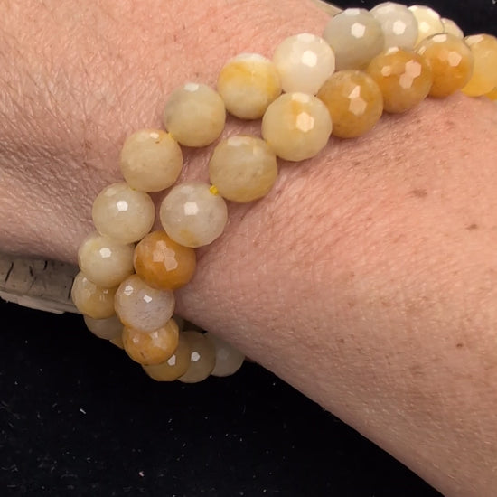 Video demonstrating the 8mm faceted Yellow Aventurine beaded stretch bracelet in motion, highlighting the light-catching geometric cuts and the natural golden aventurescent shimmer.