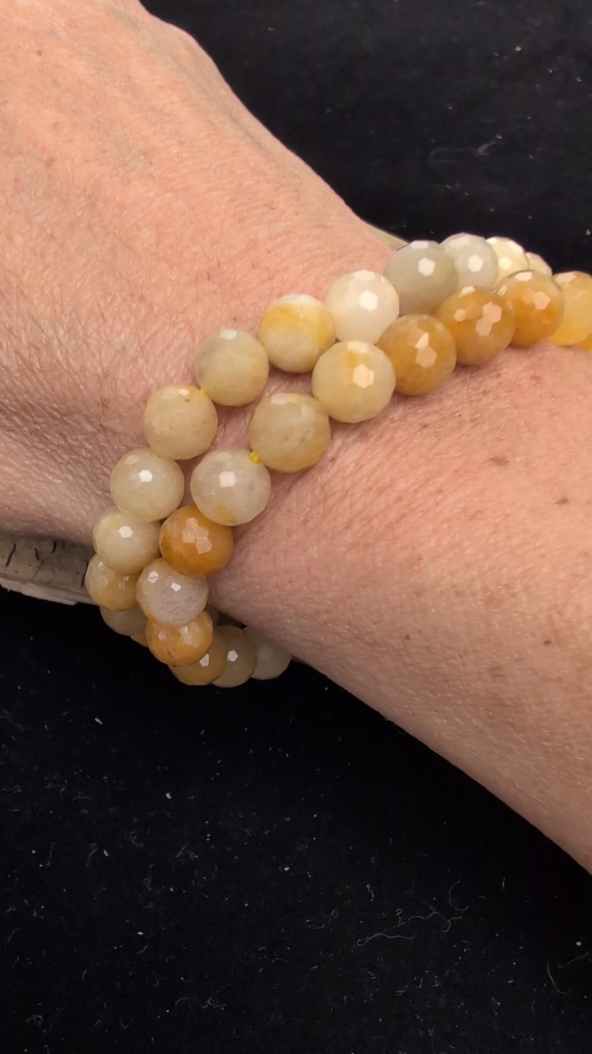 Video demonstrating the 8mm faceted Yellow Aventurine beaded stretch bracelet in motion, highlighting the light-catching geometric cuts and the natural golden aventurescent shimmer.