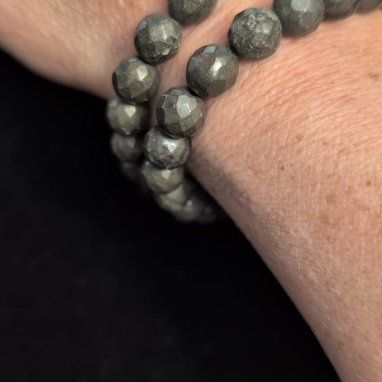Video showcasing the highly reflective faceted texture and brilliant metallic lustre of an 8mm Pyrite beaded stretch bracelet worn on a wrist.
