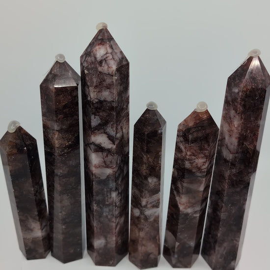 Video showcasing multiple Brazilian Fire Quartz towers in various sizes. Polished hematoid quartz points with fiery red hematite inclusions rotating under natural light
